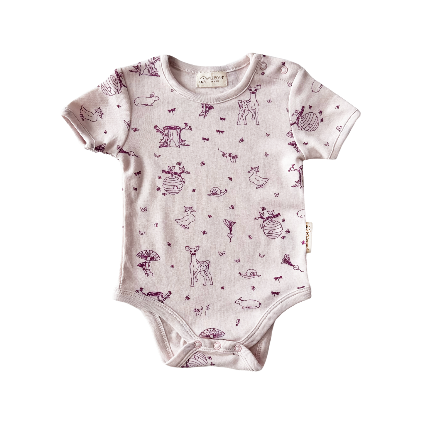 Pink Baby onesie with woodland animal pattern on a white background