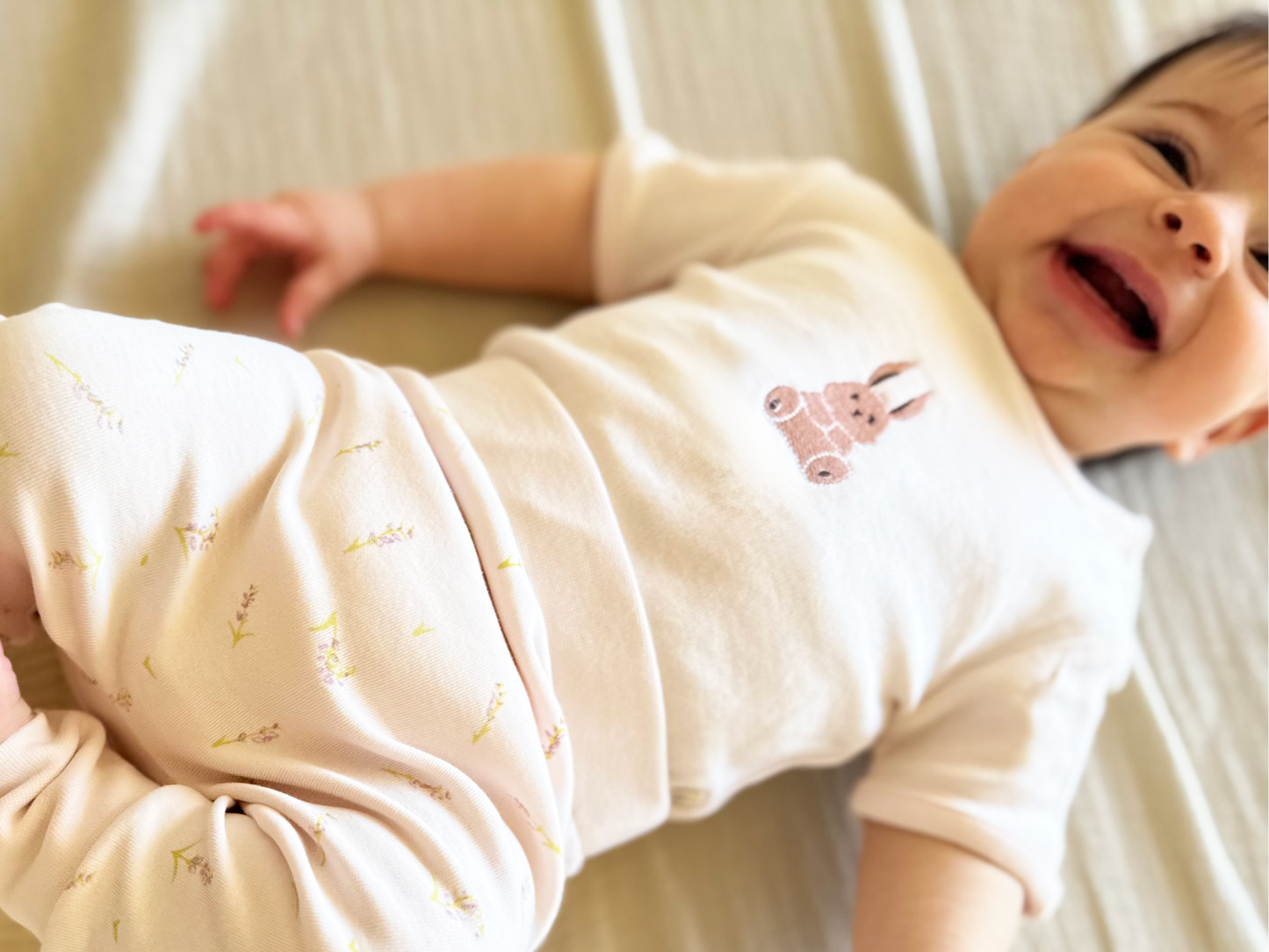 Baby in lavender and bunny themed bodysuit and pants