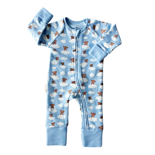 Baby onesie with bear and cloud pattern on a blue background