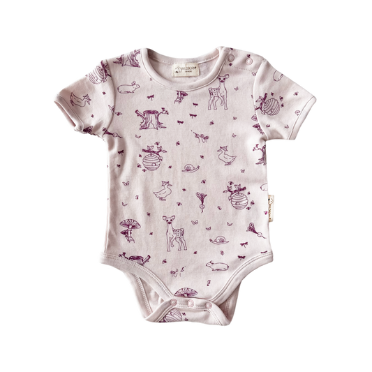 Pink Baby onesie with woodland animal pattern on a white background